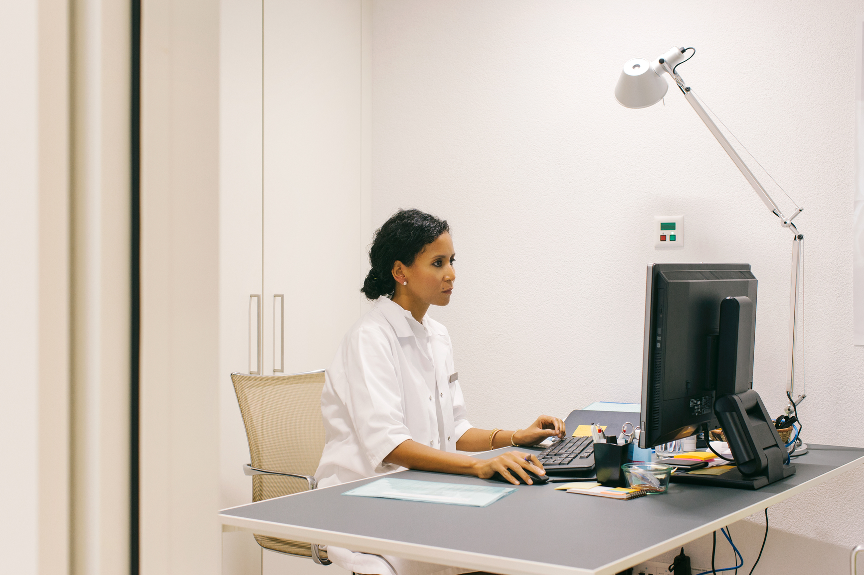 Doctor working at a computer in a medical office