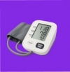 Digital blood pressure monitor with cuff on purple background