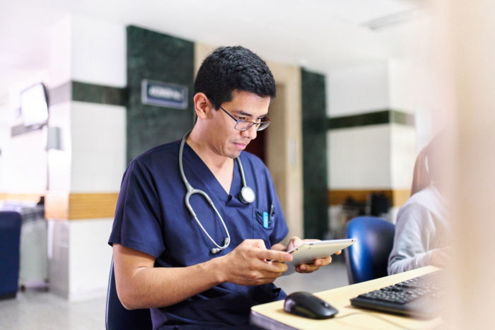 Healthcare professional using tablet in hospital office setting