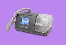 CPAP machine with hose and display on purple background