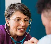 Doctor listening with a stethoscope during a patient consultation