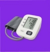 Digital blood pressure monitor with cuff on purple background