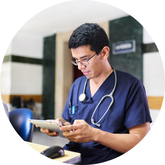 Doctor in scrubs using a tablet in a hospital setting