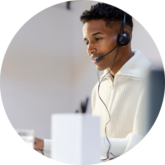 Call center agent wearing a headset working at a desk